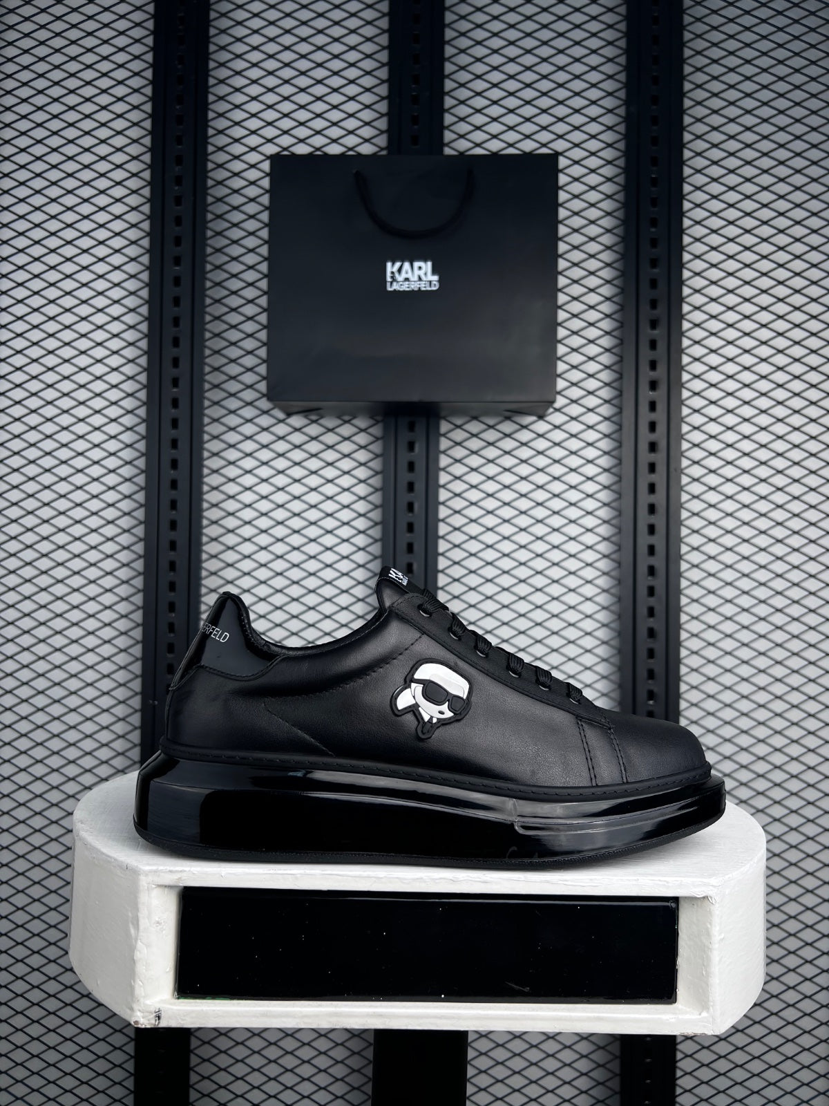 Black leather platform low-top with side figure patch