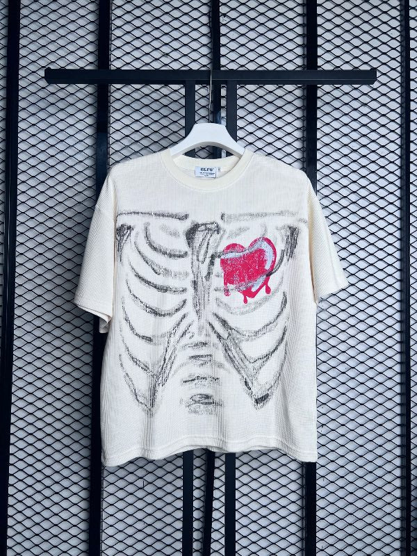 Skeleton ribcage and bleeding heart textured cream tee