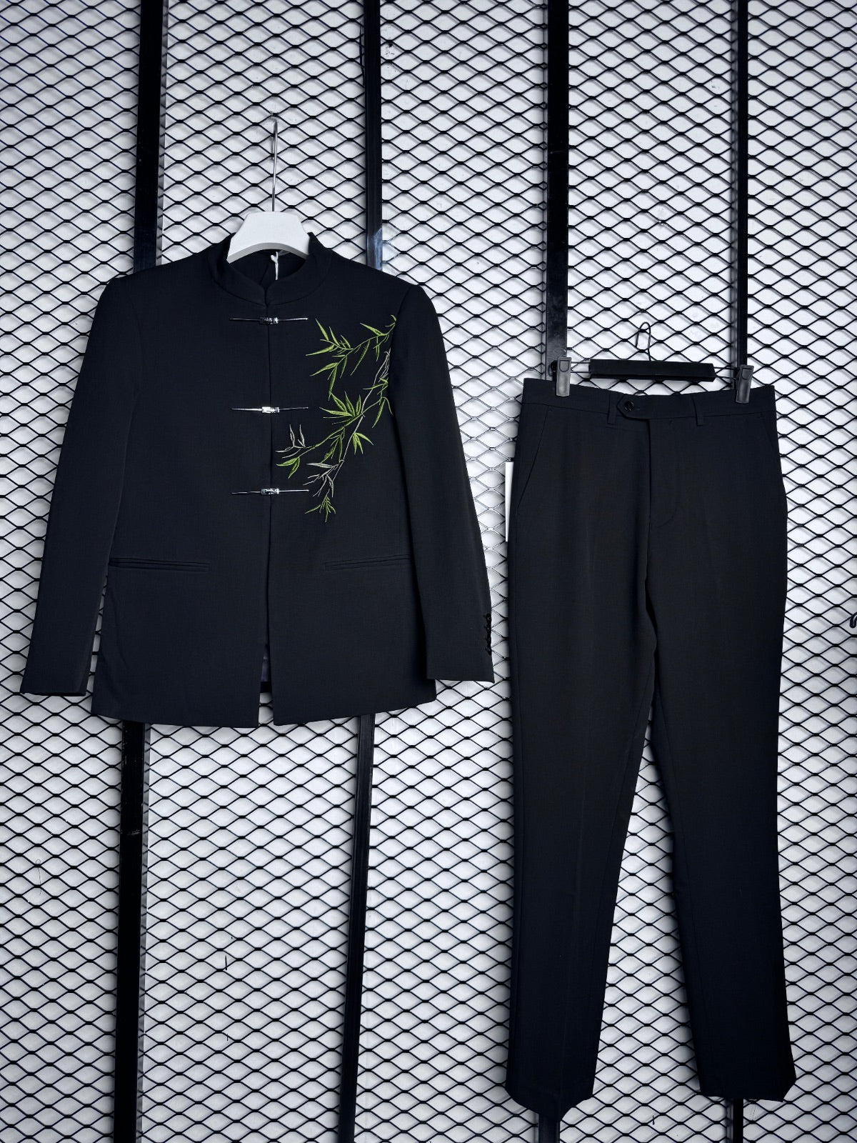 Men’s black suit set featuring distinctive bamboo leaf embroidery on the jacket
